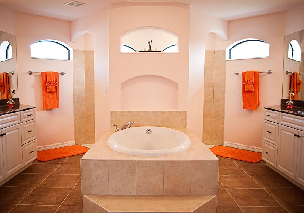 Symmetrical bathroom with a fully tiled soaking tub surround