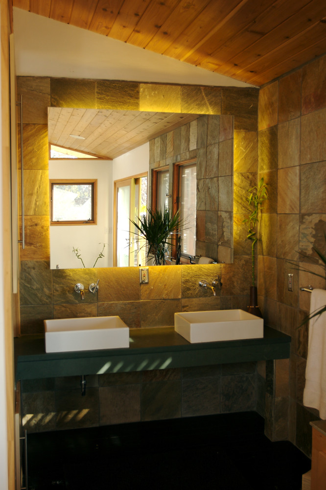 Stone-tiled double vanity with a backlit mirror