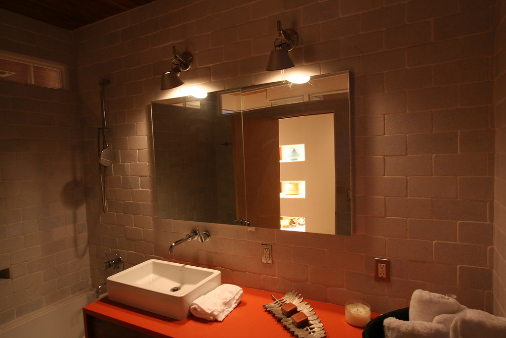 Stone-tiled bathroom wall with a vessel sink